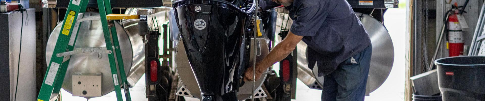Marine Mechanic working on a boat at Huntsville Marine